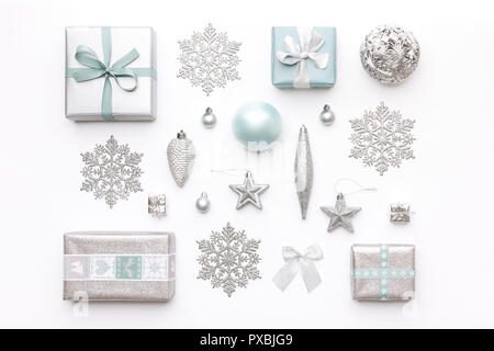 Beautiful christmas gifts and silver snowflakes and ornaments isolated on white background. Pastel blue colored wrapped xmas boxes. Christmas composit Stock Photo
