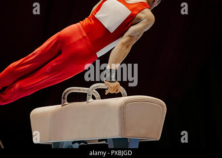 gymnast exercise pommel horse in competition artistic gymnastics