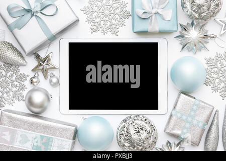 Online Christmas Shopping. Boxing Day Sale Background. Wrapped christmas presents, ornaments and blank screen digital tablet isolated over white backg Stock Photo