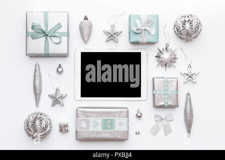 Online Christmas Shopping. Boxing Day Sale Background. Wrapped christmas presents, ornaments and blank screen digital tablet isolated over white backg Stock Photo