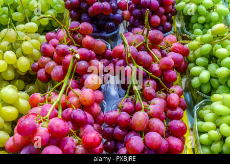 Fruits of grapevine in a plastic box for sale on the market, Palma de Mallorca, Spain Stock Photo