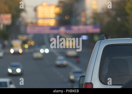 Cityscape with parts of the car on the blurred background of the road. For design and networking. Stock Photo