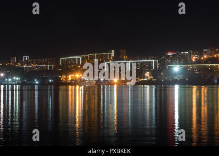 Vladivostok, Russia-October 20, 2018: Urban landscape with silhouettes of houses and light from lanterns. Stock Photo