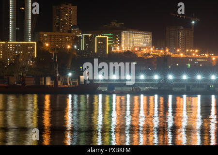 Vladivostok, Russia-October 20, 2018: Urban landscape with silhouettes of houses and light from lanterns. Stock Photo