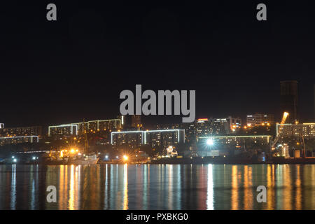 Vladivostok, Russia-October 20, 2018: Urban landscape with silhouettes of houses and light from lanterns. Stock Photo