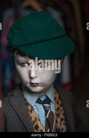 A vintage mannequin of a boy in shirt and tie and wearing a schoolboy's cap. Stock Photo