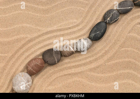 Zigzag made of stones among sand dunes. Top view Stock Photo