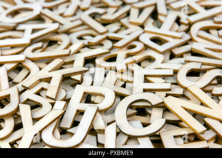 Pile of mixed wooden capital letters close up with a shallow depth of field Stock Photo