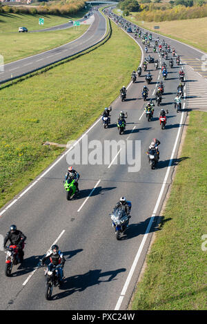 Memorial motorcycle ride for Liam Holding, 24, killed in a road accident whilst riding his motorbike on the A12 in Colchester, Essex. The family have asked for donations to Air Ambulance who attended scene but could not save him. Motorcyclists riding on A130 in tribute Stock Photo