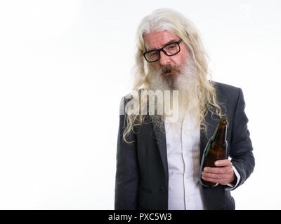 Studio shot of senior bearded businessman holding bottle of beer Stock Photo