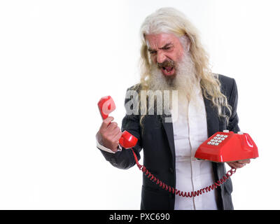 Studio shot of angry senior bearded businessman shouting at old  Stock Photo