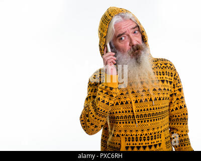 Studio shot of senior bearded man wearing hoodie while talking o Stock Photo