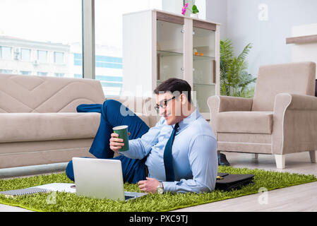Businessman taking work home and working overtime Stock Photo