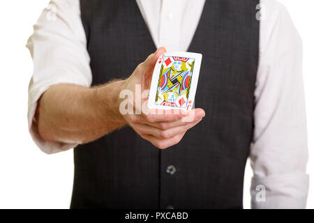 Caucasian magician man holding and bending Jack of Diamonds card Stock Photo