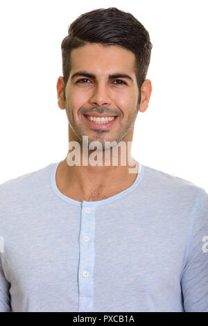 Face of young happy Persian man smiling Stock Photo