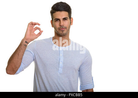 Young handsome Persian man giving ok sign Stock Photo