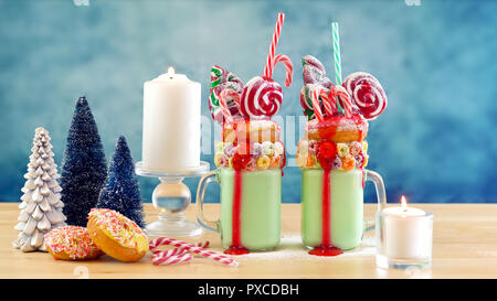 On trend Christmas freakshake milkshakes in colorful party table setting. Stock Photo