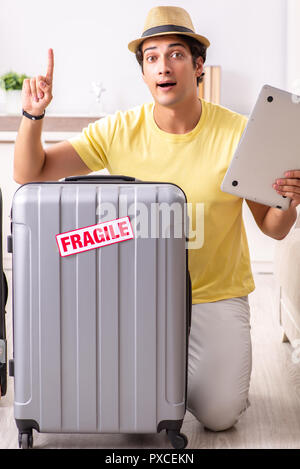 Man going on vacation with fragile suitcases Stock Photo