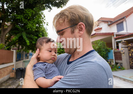 Father and baby son bonding together at home outdoors Stock Photo