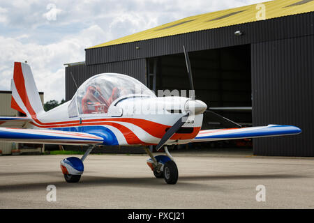 outdoor shot of small plane standing in shed Stock Photo