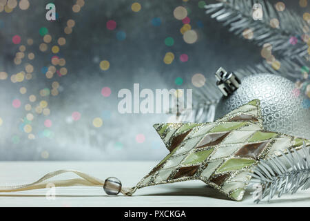 christmas tree decorations and fir tree branches on grey background Stock Photo