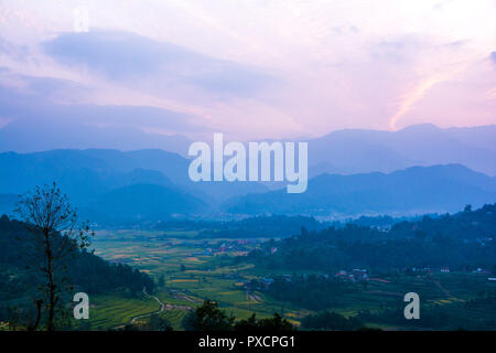 Farm field and layered hills Stock Photo