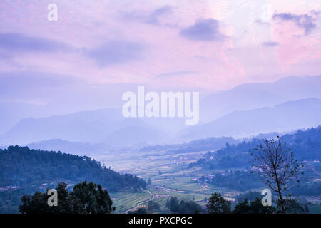 Farm field and layered hills Stock Photo