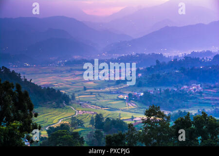 Farm field and layered hills Stock Photo