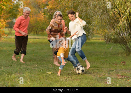 Portrait of big happy family playing football in park Stock Photo