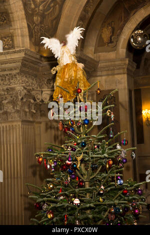UK, England, Yorkshire, Castle Howard at Christmas, Great Hall, angel on top of  huge decorated Christmas Tree Stock Photo