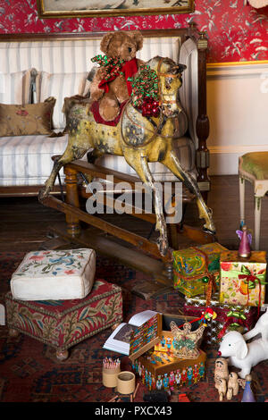 UK, England, Yorkshire, Castle Howard at Christmas, Dressing Room, teddy bear riding traditional wooden rocking horse Stock Photo