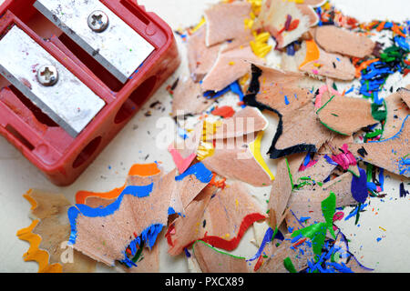 Sharpener and colored pencil shavings Stock Photo