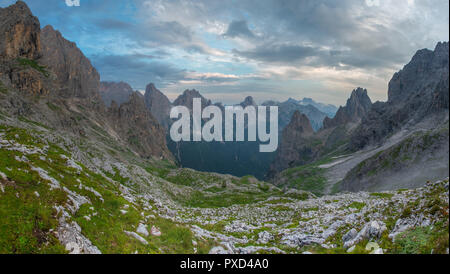 Ominous clouds signal the approach of a summer storm in the mountains. Sunset after a hard hike. Italian Alps scapes. Stock Photo
