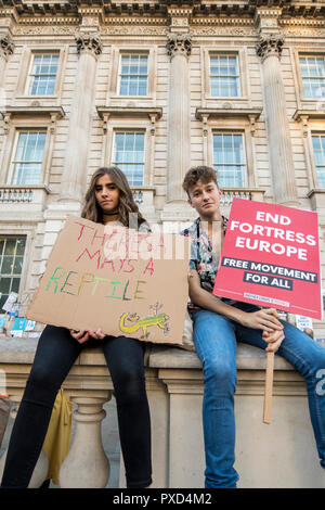 Two teenagers pose with placards during the People's Vote march on Whitehall, London. Stock Photo