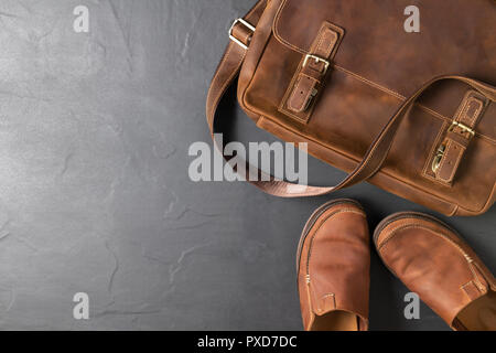 Leather Vintage bag and leatrher Casual Shoes on black stone background with copy space, accessories costume concept Stock Photo