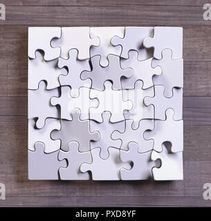 Blank puzzle in square format with wooden background. Concept of modern art using simple objects. Stock Photo