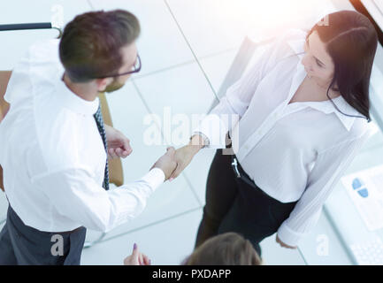 handshake manager and employee near the workplace Stock Photo