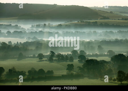 Morning mist hangs in valleys of the the South Downs National Park on an autumn morning, near Bishops Waltham, Hampshire, UK Saturday October 20, 2018 Stock Photo
