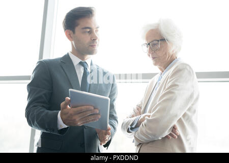 Thoughtful business analysts browsing internet Stock Photo