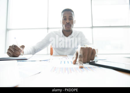 Concentrated financial advisor examining papers Stock Photo