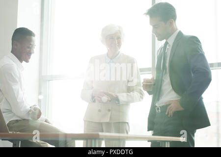 Cheerful business specialists discussing strategy at meeting Stock Photo