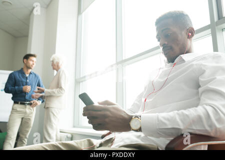 Relaxed African employee in office Stock Photo