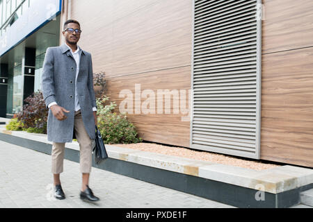 Fashionable African businessman leaving office Stock Photo