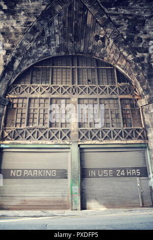 No parking place, in use 24 hours notice on old rusty vintage paint corrugated iron garage, Edinburgh, Scotland, United Kingdom, autonomous self-drivi Stock Photo