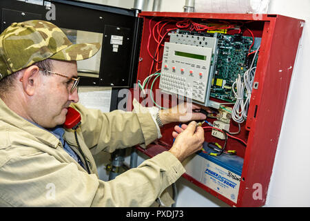 Miami Florida,Overtown,Black Police Precinct & Courthouse Museum,fire alarm mechanic,repair,repairman,man men male adult adults,wire,electronic securi Stock Photo