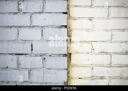 An interesting brick wall painted in two colors : gray and white Stock Photo