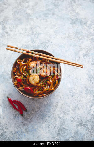 Traditional asian udon stir-fry noodles with shrimp Stock Photo
