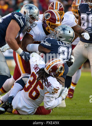 Dallas Cowboys running back Ezekiel Elliott (21) is gang-tackled by Washington Redskins free safety D.J. Swearinger (36), defensive end Jonathan Allen (93) and linebacker Preston Smith (94) in first quarter action at FedEx Field in Landover, Maryland on Sunday, October 21, 2018. Credit: Ron Sachs/CNP | usage worldwide Stock Photo