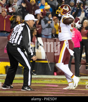 Washington Redskins linebacker Preston Smith (94) celebrates his fourth quarter touchdown against the Washington Redskins at FedEx Field in Landover, Maryland on Sunday, October 21, 2018. Looking on is referee John Hussey (35). The Redskins won the game 20 - 17. Credit: Ron Sachs/CNP | usage worldwide Stock Photo