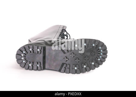 Screwed on black combat work boot soles. isolated on white Stock Photo